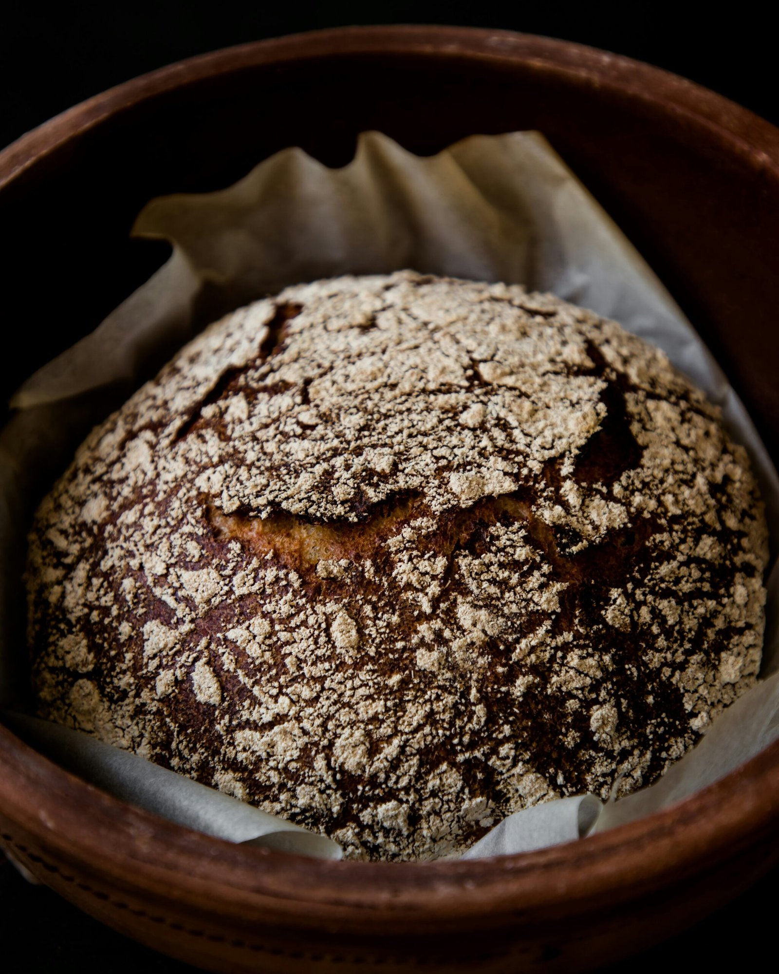 a loaf of bread in a wooden bowl